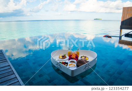 Floating breakfast in a heart shape in the pool in Maldives Floating breakfast in a heart shape in the pool in Maldives 123354277