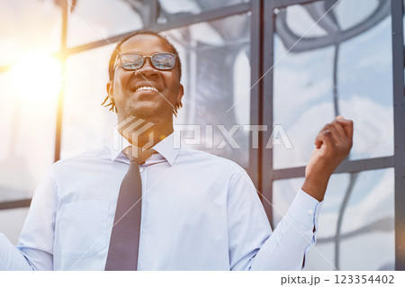 man in a modern office listening to music with white headphones 123354402