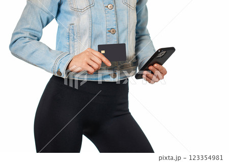 female hand holding mobile phone and black premium credit bank card on white background. Online shopping. female hand holding mobile phone and black premium credit bank card on white background. Online shopping. 123354981