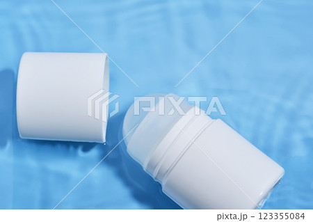 Roll-on deodorant on a blue background in water. 123355084