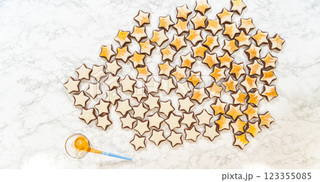 An artistic top-down arrangement of gingerbread star cookies decorated with royal icing, with gold luster dust adding a glamorous finish to these festive treats. An artistic top-down arrangement of gingerbread star cookies decorated with royal icing, with gold luster dust adding a glamorous finish to these festive treats. 123355085