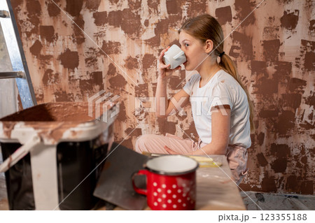 A Young Girl Enjoying a Relaxing Break While Engaged in Her Beautiful Painting Activity A Young Girl Enjoying a Relaxing Break While Engaged in Her Beautiful Painting Activity 123355188