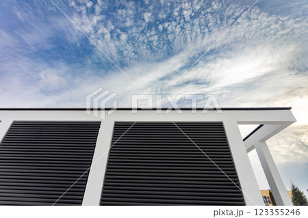Modern Architectural Detail Highlighted Against a Dramatic and Cloudy Sky Backdrop 123355246