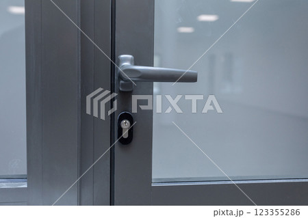 This is a stylish Modern Glass Door featuring a sleek Metal Handle and a reliable Lock system This is a stylish Modern Glass Door featuring a sleek Metal Handle and a reliable Lock system 123355286