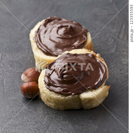 Chocolate spread on bread and filbert  on concrete backgrounds 123355593