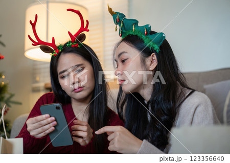 Focused Lesbian Partners Reviewing Holiday Shopping List Precision in Festive Finance Focused Lesbian Partners Reviewing Holiday Shopping List Precision in Festive Finance 123356640