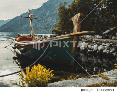 Wooden Boat Docked by Scenic Lakeside by Adriatic sea in the Kotor bay Wooden Boat Docked by Scenic Lakeside by Adriatic sea in the Kotor bay 123356694