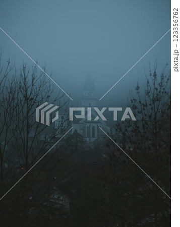 Church Tower of Saint Catherine Cathedral in Kremnica Slovakia Emerging Through Dense Fog 123356762