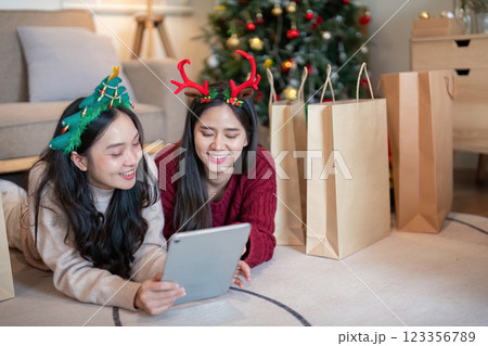 LGBT Female Friends Celebrating Festive Holidays with Technology and Shared Joy 123356789
