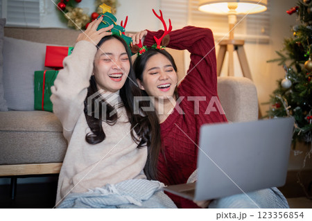 Lesbian Couple Relishing in Holiday Laughter and Connection Lesbian Couple Relishing in Holiday Laughter and Connection 123356854