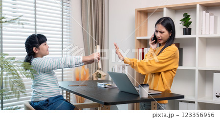 Work-Home Dynamics Mother Managing Calls with Daughter 123356956