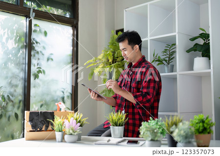 Gardener Using Tablet for Plant Care and Management 123357073
