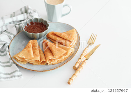 Crepes with chocolate cream and coffee on white wooden table. Pancake day, Maslenitsa Crepes with chocolate cream and coffee on white wooden table. Pancake day, Maslenitsa 123357667