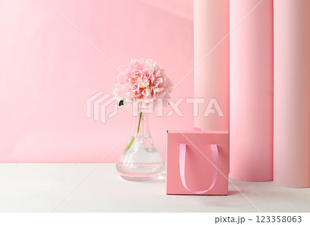 Abstract floral arrangement, fresh peony flowers and gift box. Card for congratulations on Mother's Day, wedding, Women's Day. Minimal modern aesthetics. elegant beauty concept, selective focus 123358063