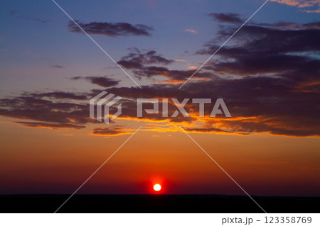 beautiful colored sky and thick clouds at sunset on field horizon beautiful colored sky and thick clouds at sunset on field horizon 123358769