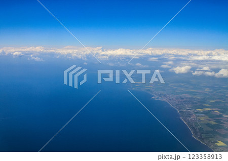 beautiful thick clouds in the sky from the height of the flight of the plane with a view of the continent and countries 123358913