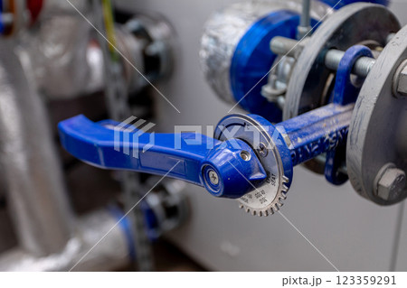 CloseUp of a Blue Valve Handle in Industrial Settings, highlighting its significance and function 123359291