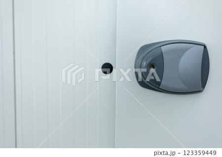 A Modern Lock Installed on a Minimalistic White Door That Enhances Overall Aesthetic Appeal 123359449