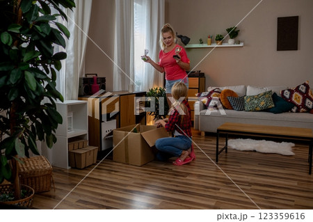 Delighted Children Excitedly Unboxing Treasures in a Cozy Living Room Setting Full of Cheer 123359616