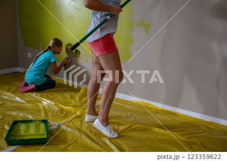 Children joyfully painting a room using various bright and colorful colors with enthusiasm 123359622
