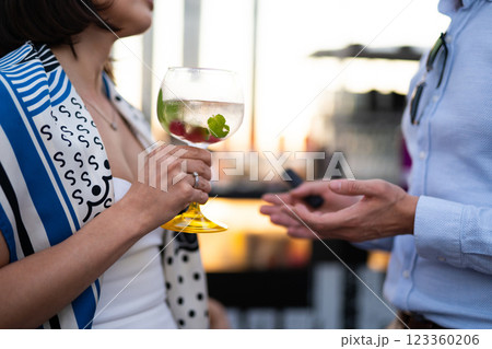 holding cool fresh alcoholic cocktail in hands at party 123360206