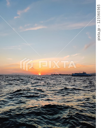 beautiful dramatic landscape of sunset on sea beach with silhouette of boat beautiful dramatic landscape of sunset on sea beach with silhouette of boat 123360365
