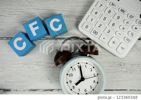 CFC (Cash Flow Control) text with alarm clock and calculator on wooden background 123360388