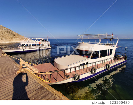 beautiful ships and boats are moored near the shore beautiful ships and boats are moored near the shore 123360489