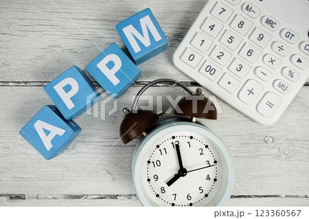 APPM (Average Price Per Minute) text with alarm clock and calculator on wooden background APPM (Average Price Per Minute) text with alarm clock and calculator on wooden background 123360567
