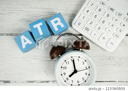 ATR (Average True Range) text with alarm clcok and calculator on wooden background ATR (Average True Range) text with alarm clcok and calculator on wooden background 123360809