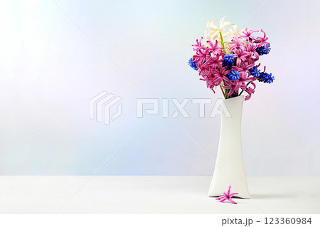 Beautiful spring flowers hyacinths and muscari in a vase on a light background, flyer.Abstract floral composition, still life with space for text, floral holiday card, summer greeting concept, Beautiful spring flowers hyacinths and muscari in a vase on a light background, flyer.Abstract floral composition, still life with space for text, floral holiday card, summer greeting concept, 123360984