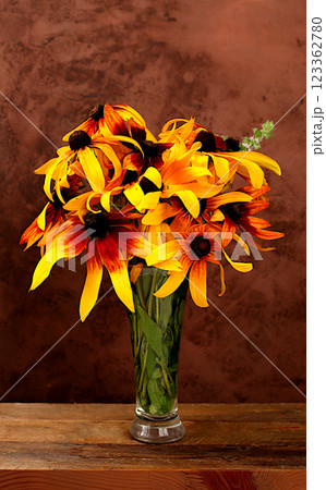 Beautiful still life with bouquet of rudbeckia on old wooden table, autumn banner, abstract floral arrangement, rustic style, holiday card and screen template with place for text, selective focus. 123362780