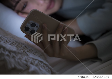 ベッドでスマホを見る女性 ベッドでスマホを見る女性 123363285