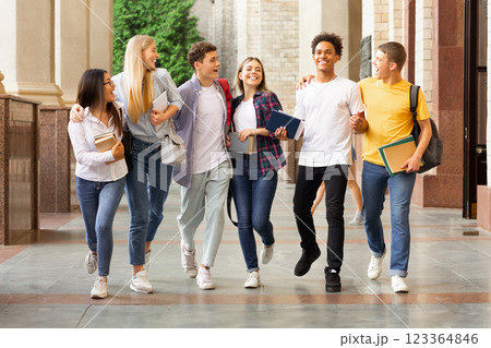 Successful tests. Students walking in university campus and chatting outdoors 123364846