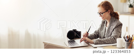 Young reporter transfering image data from camera to laptop, ready to write new article Young reporter transfering image data from camera to laptop, ready to write new article 123364853