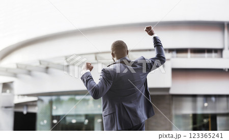 African american job seeker celebrating successful interview raising fists against business center, rear view with copy space 123365241