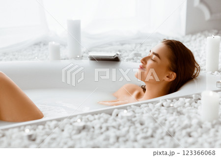 Beautiful Woman Relaxing In Milky Bathtub, Lying With Closed Eyes 123366068