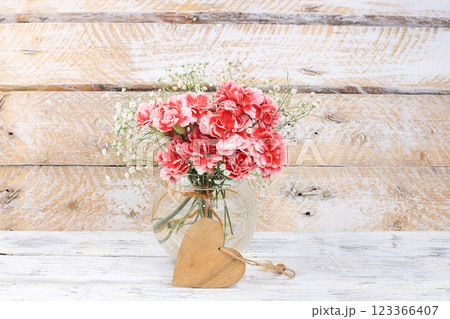Carnations in a vase, abstract spring floral background, still life. Creative modern bouquet, minimal holiday concept. Postcard for womens day or mothers day, happy birthday, wedding, banner for the Carnations in a vase, abstract spring floral background, still life. Creative modern bouquet, minimal holiday concept. Postcard for womens day or mothers day, happy birthday, wedding, banner for the 123366407