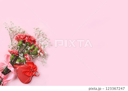 Flowers with pink ribbon, abstract floral arrangement, spring banner. Creative modern bouquet, minimal holiday concept, selective focus. Postcard for mothers day, womens day, happy birthday, place for 123367247