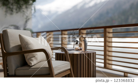 A wooden arm chair with pillow places beside the round table on the balcony with mountain view. A wooden arm chair with pillow places beside the round table on the balcony with mountain view. 123368832