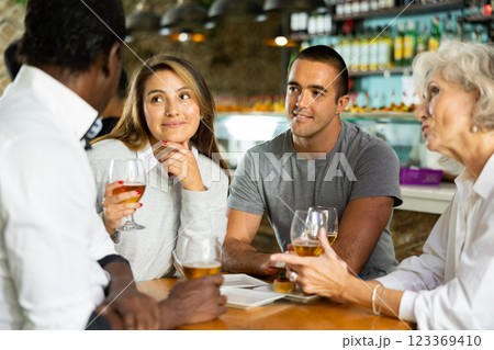 Happy diverse group having a conversation at a bar 123369410