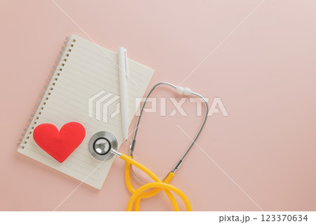 Healthcare Heroes on Pink. Show thanks on Doctor Day with a stethoscope, notepad, pen, and red heart Healthcare Heroes on Pink. Show thanks on Doctor Day with a stethoscope, notepad, pen, and red heart 123370634