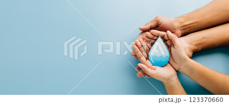 Celebrate World Water Day. Two hands cradle a water drop cutout, highlighting clean water, hygiene 123370660