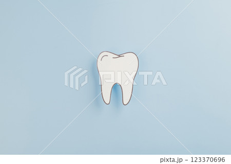 Dentist Day, a tooth paper cut shape represents dental health on blue 123370696