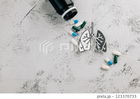 Lungs pills and medicine bottle represent World TB Day on gray background. 123370733