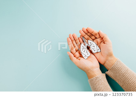 Lungs paper held by two hands represents World TB Day. Raising awareness about tuberculosis 123370735