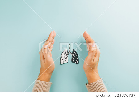 Celebrate World TB Day with hands cradling lungs paper. Raising awareness about lungs health, 123370737