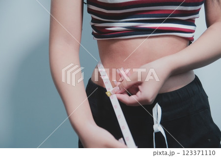 Women body fat belly. Obese woman hand holding excessive belly fat. diet lifestyle concept to reduce belly and shape up healthy stomach muscle. Women body fat belly. Obese woman hand holding excessive belly fat. diet lifestyle concept to reduce belly and shape up healthy stomach muscle. 123371110