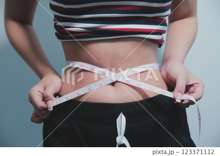 Women body fat belly. Obese woman hand holding excessive belly fat. diet lifestyle concept to reduce belly and shape up healthy stomach muscle. Women body fat belly. Obese woman hand holding excessive belly fat. diet lifestyle concept to reduce belly and shape up healthy stomach muscle. 123371112