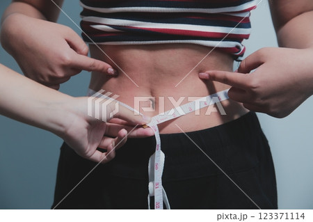 Women body fat belly. Obese woman hand holding excessive belly fat. diet lifestyle concept to reduce belly and shape up healthy stomach muscle. Women body fat belly. Obese woman hand holding excessive belly fat. diet lifestyle concept to reduce belly and shape up healthy stomach muscle. 123371114